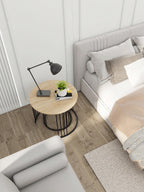 Modern bedroom with a bed, side table, and lamp.